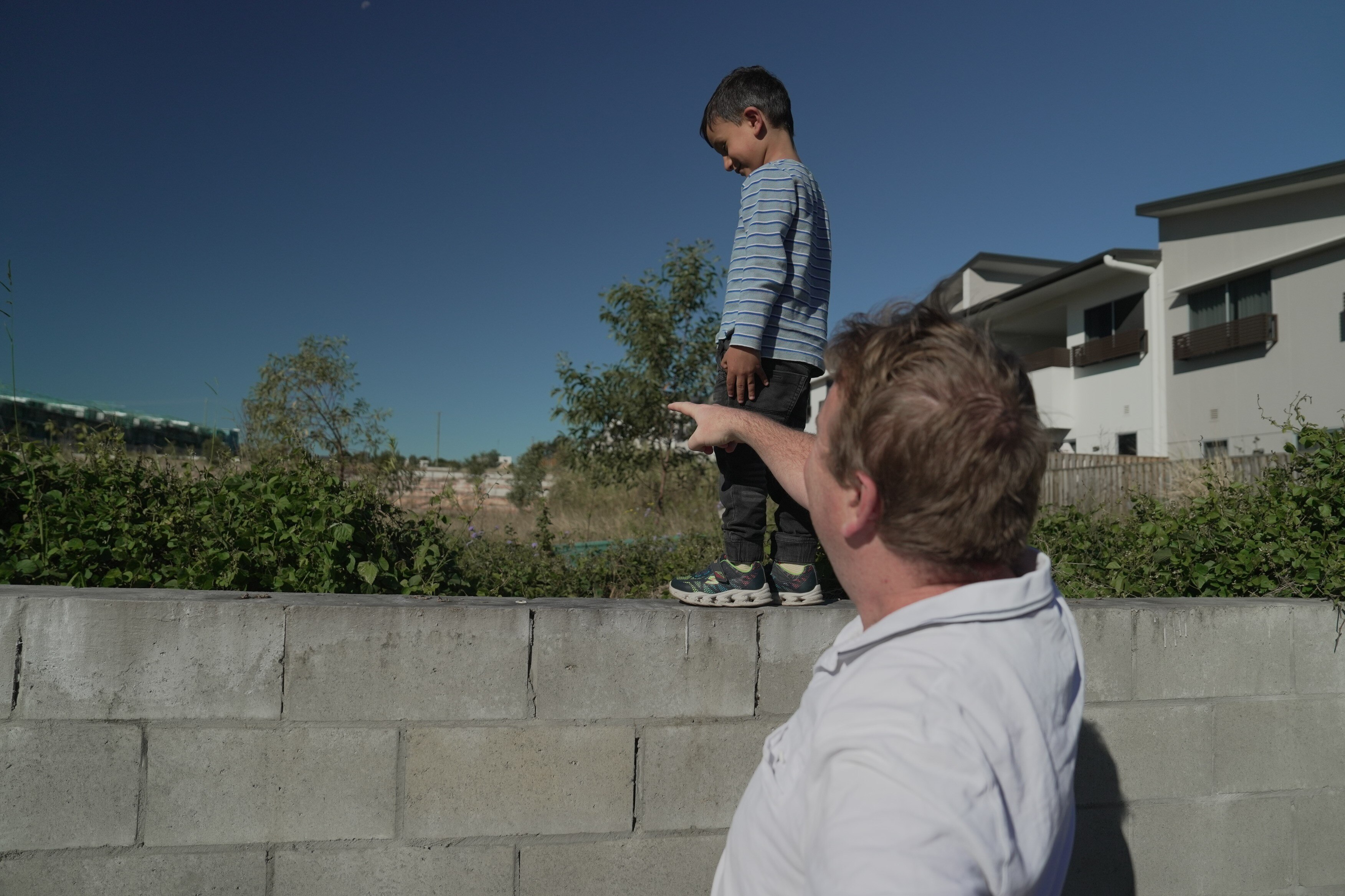 Mr McInnes' son walking along the wall overlooking the development. 