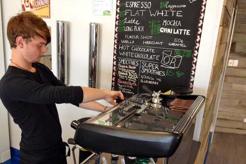 Burnie man Brandon Fletcher-Jones makes coffee at Hilltop Foods.