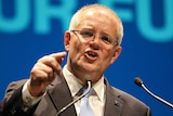 Scott Morrison points as he speaks into microphones at a lectern at the Coalition's federal election campaign launch.