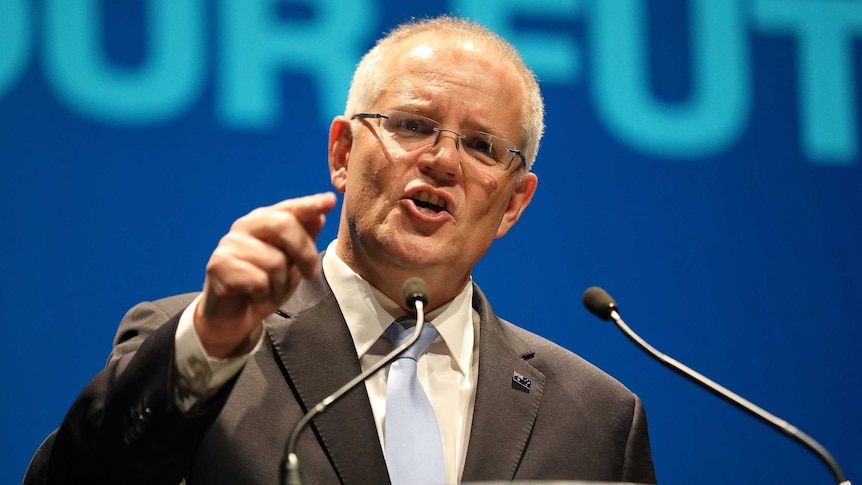 Scott Morrison points as he speaks into microphones at a lectern at the Coalition's federal election campaign launch.