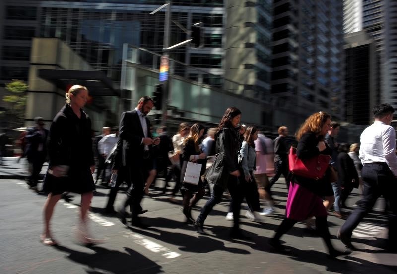 Office workers cross the street in Sydney