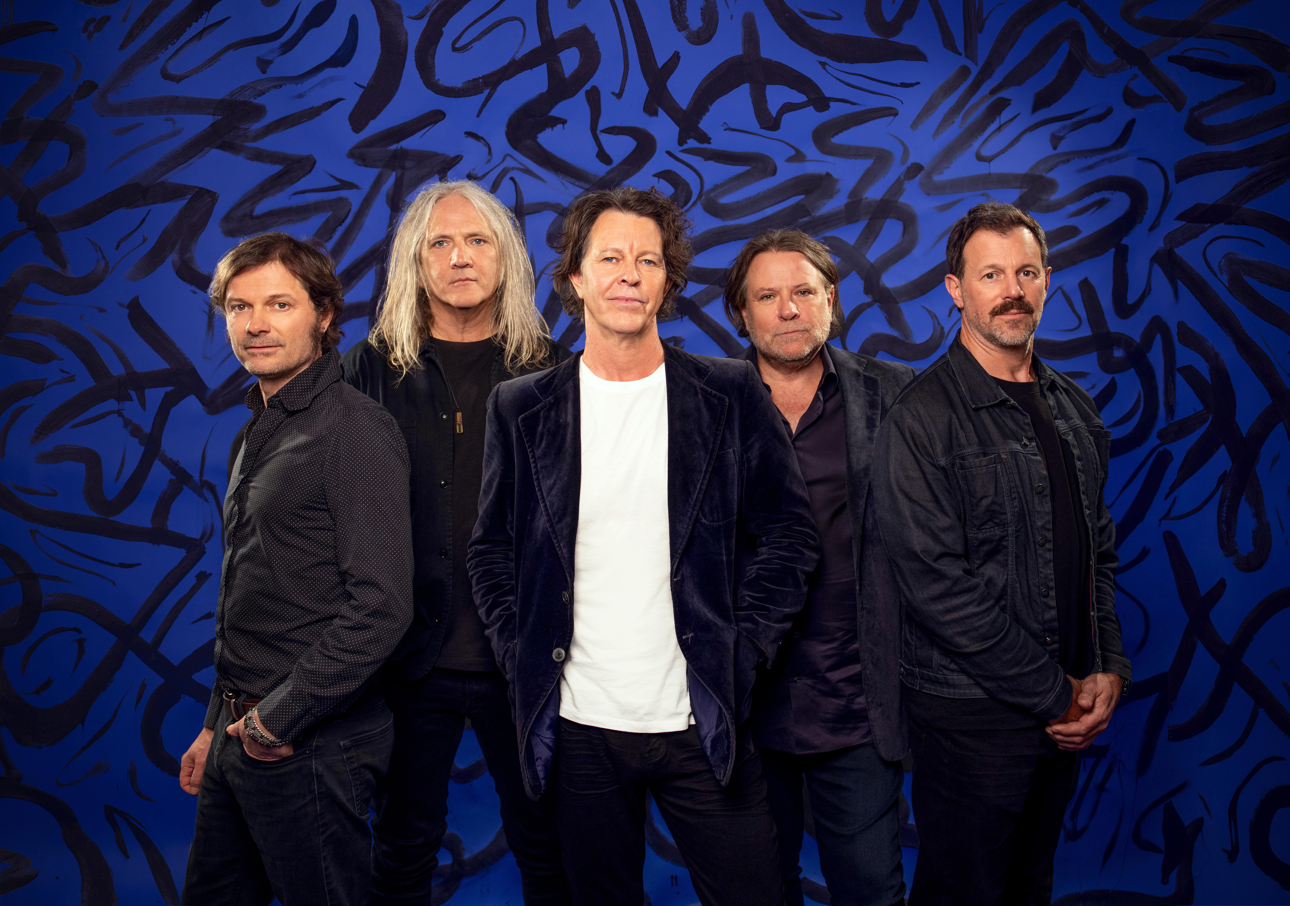 Powderfinger band members wear black, with Bernard Fanning in black, with a white T-shirt.
