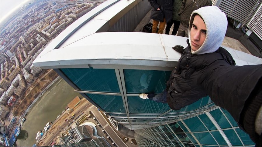 Russian daredevil Kirill Oreshkin takes a dangerous selfie from an unidentified tower
