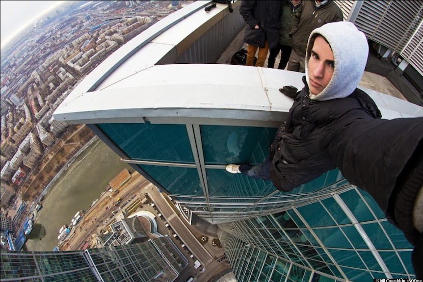 Russian daredevil Kirill Oreshkin takes a dangerous selfie from an unidentified tower