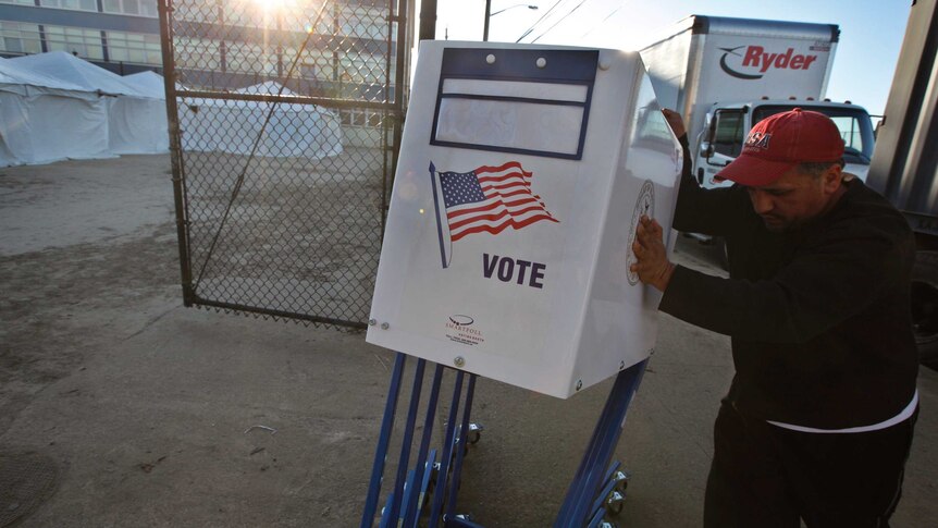 A man delivers voting machines to a makeshift polling centre in Rockaways in Queens, New York, November 5, 2012.