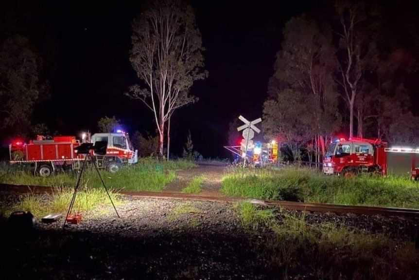 Fire trucks attend a train that hit a fallen tree near Grafton, NSW