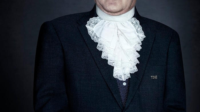 A portrait photograph of a New York City doormen in his uniform.