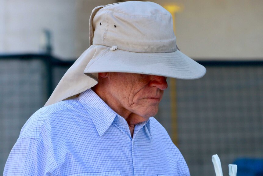 Former public servant David Eastman, wearing a large hat, arrives at court.