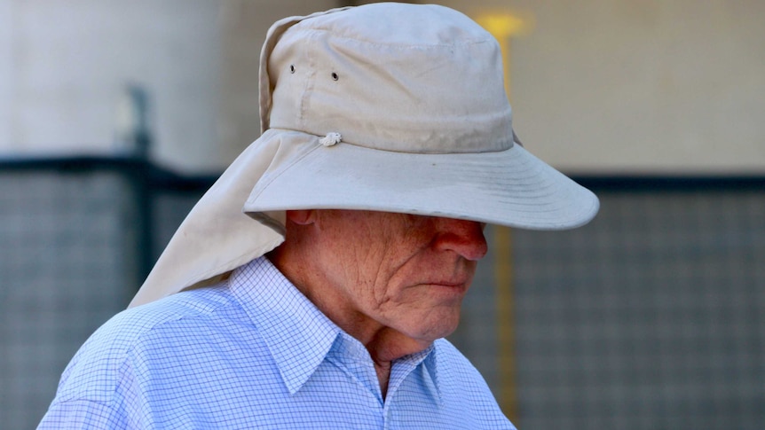 Former public servant David Eastman, wearing a large hat, arrives at court.
