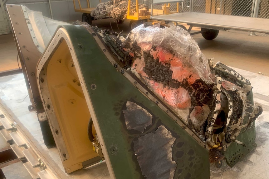 The front of a helicopter that was melted by fire.