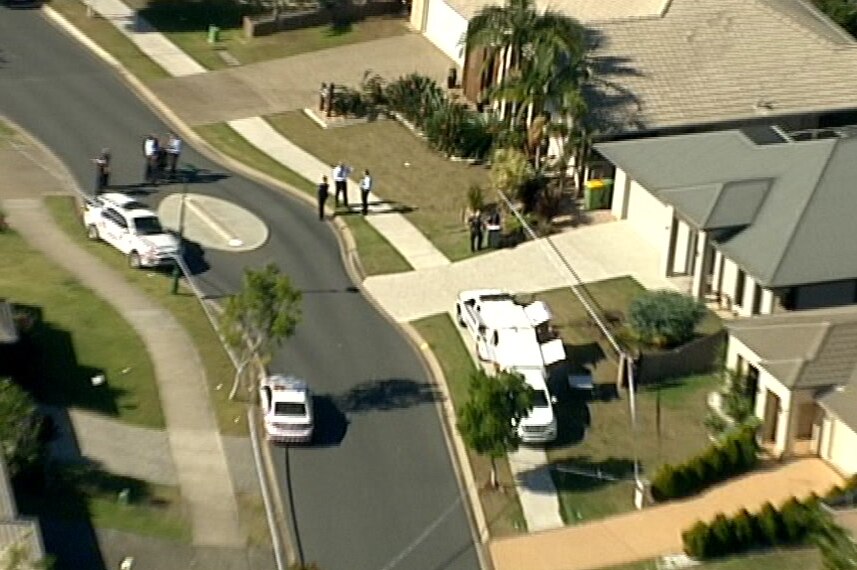 Police surround a suburban home