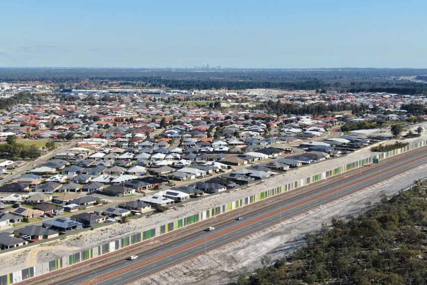 An aerial shot of a suburban neighbourhood surrounded by bush