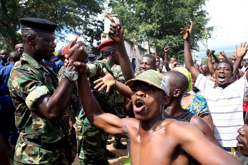 People greet soldiers in Burundi
