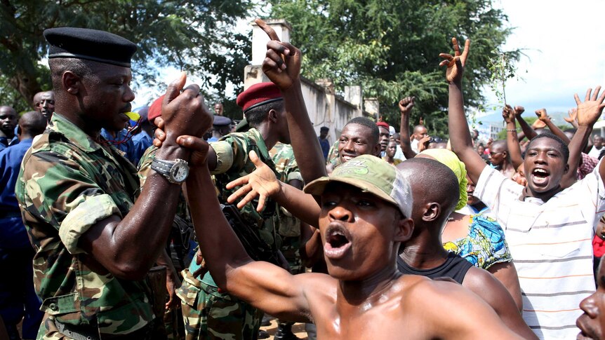People greet soldiers in Burundi