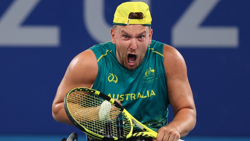 An Australian male quad singles player screams out as he celebrates winning his Tokyo Paralympics semi-final.