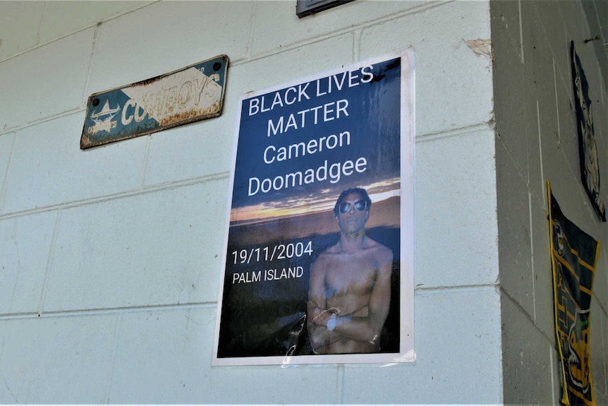 A laminated sign reads Black Lives Matter Cameron Doomadgee 19/11/2004 Palm Island