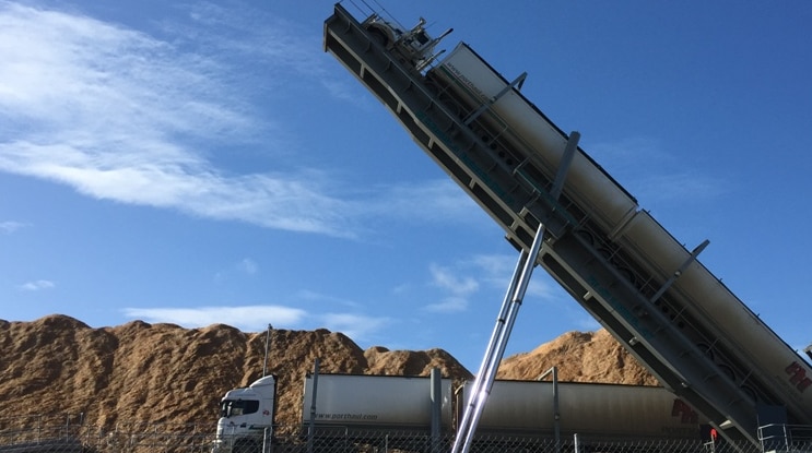 Wood chips being offloaded from a truck