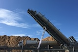 Wood chips being offloaded from a truck