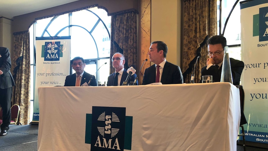 A panel of politicians sit at a table alongside AMA SA president Professor William Tam.