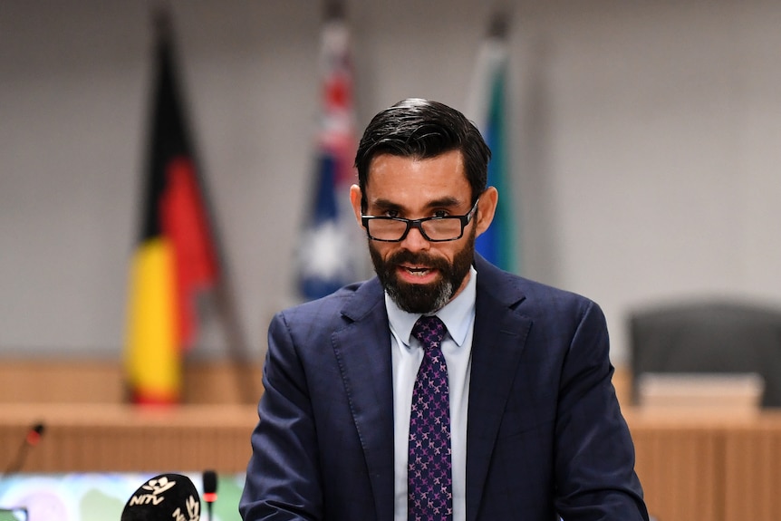  Lincoln Crowley with a beard and glasses with indigenous flag behind him.