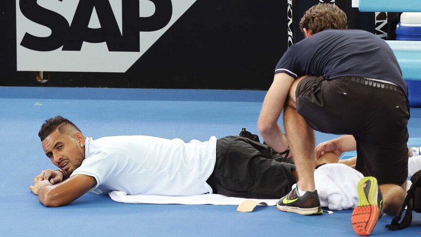 Australia's Nick Kyrgios is treated for an injury at the Brisbane International on January 3, 2018.
