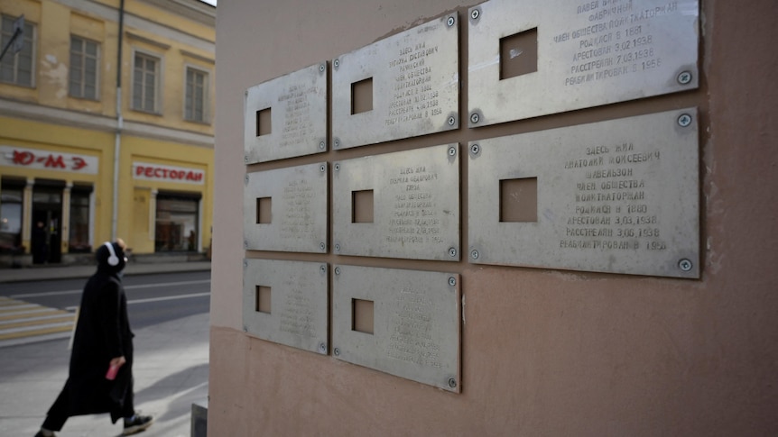 Commemorative plaques are seen on a wall of an apartment building in Moscow.