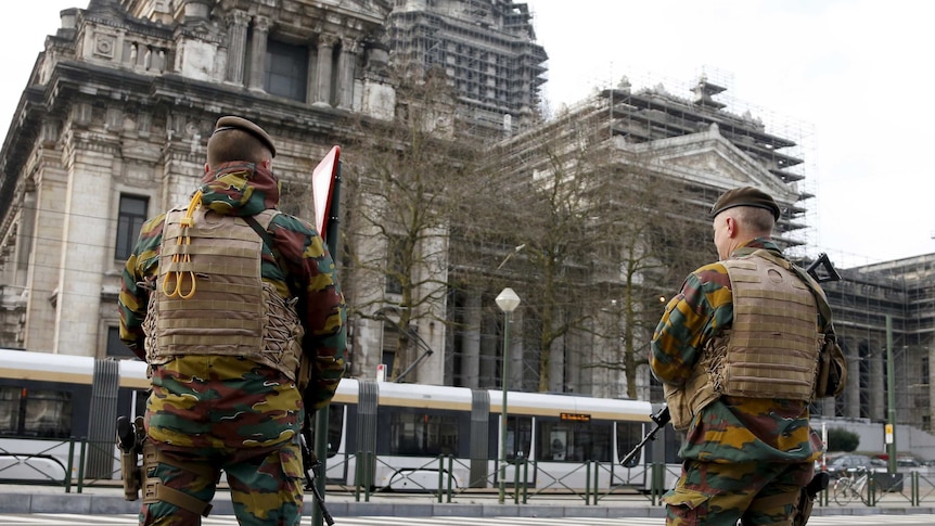 Belgian soldiers stand guard outside Palace of Justice