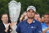 Jason Day holds the trophy after winning the first PGA Tour playoff event