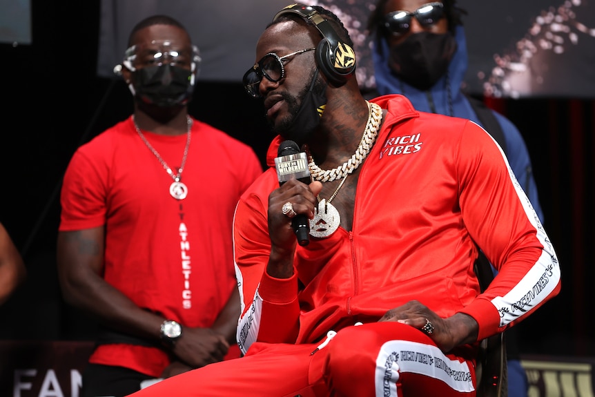 Deontay Wilder speaks into a microphone