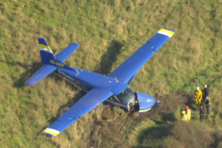A damaged plane in a field.