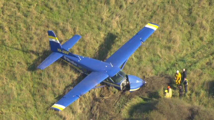 A damaged plane in a field.