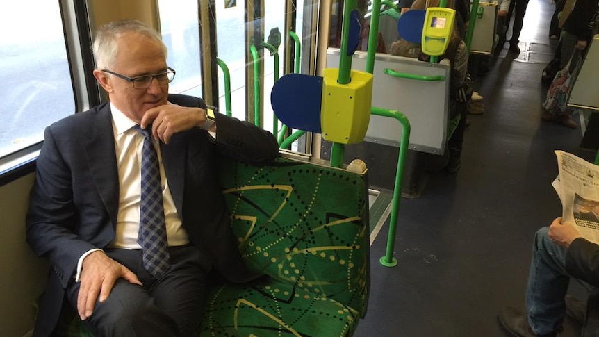 Prime Minister Malcolm Turnbull on a tram in on AFL grand final eve, 2015.