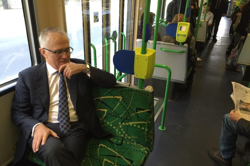 Prime Minister Malcolm Turnbull on a tram in on AFL grand final eve, 2015.