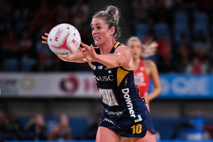A Sunshine Coast Lightning Super Netball player reaches out for the ball.
