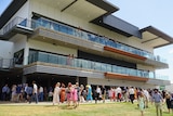 The Darwin Turf Club grandstand packed with spectators on a Darwin race day.