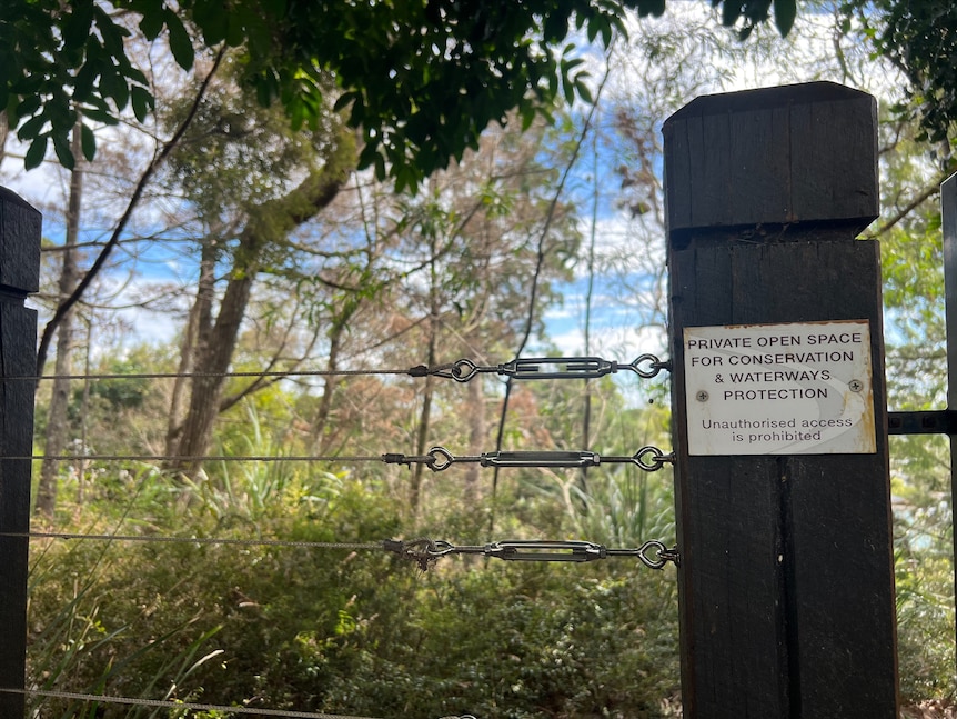 Fence post with sign 'private open space for conservation'