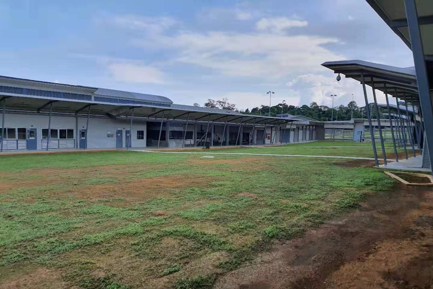 A housing compound on Christmas Island adjacent to a green lawn.