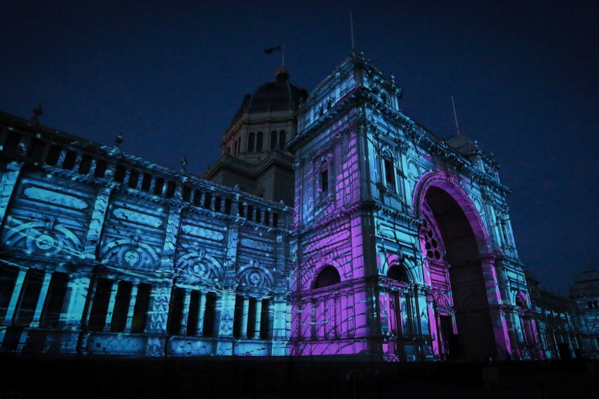 A purple and blue light projection covers the walls of Melbourne's Exhibition Hall during White Night. February 17, 2018.