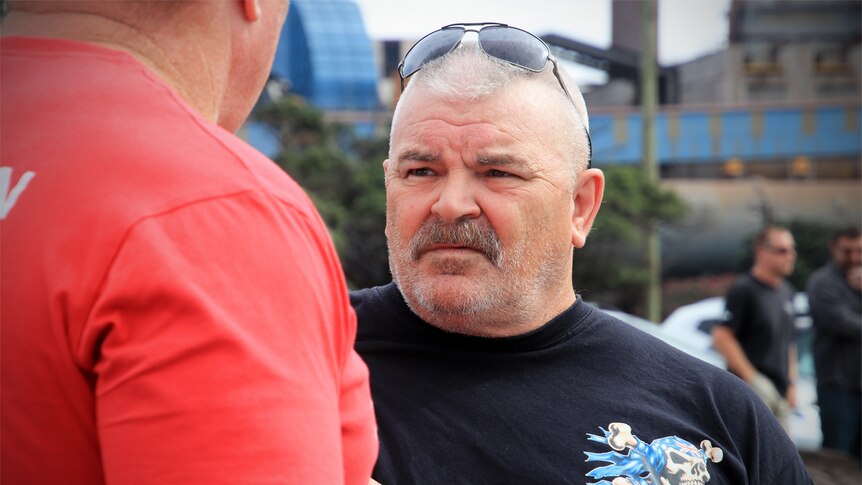 James Lisney stands at Port Kembla talking to Mick Cross.