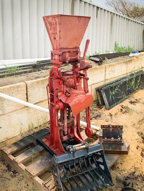 A brickmaking machine made of red metal
