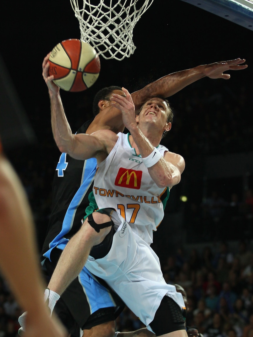 To the rack ... Mika Vukona (unseen) attempts a block on Townsville's Peter Crawford.