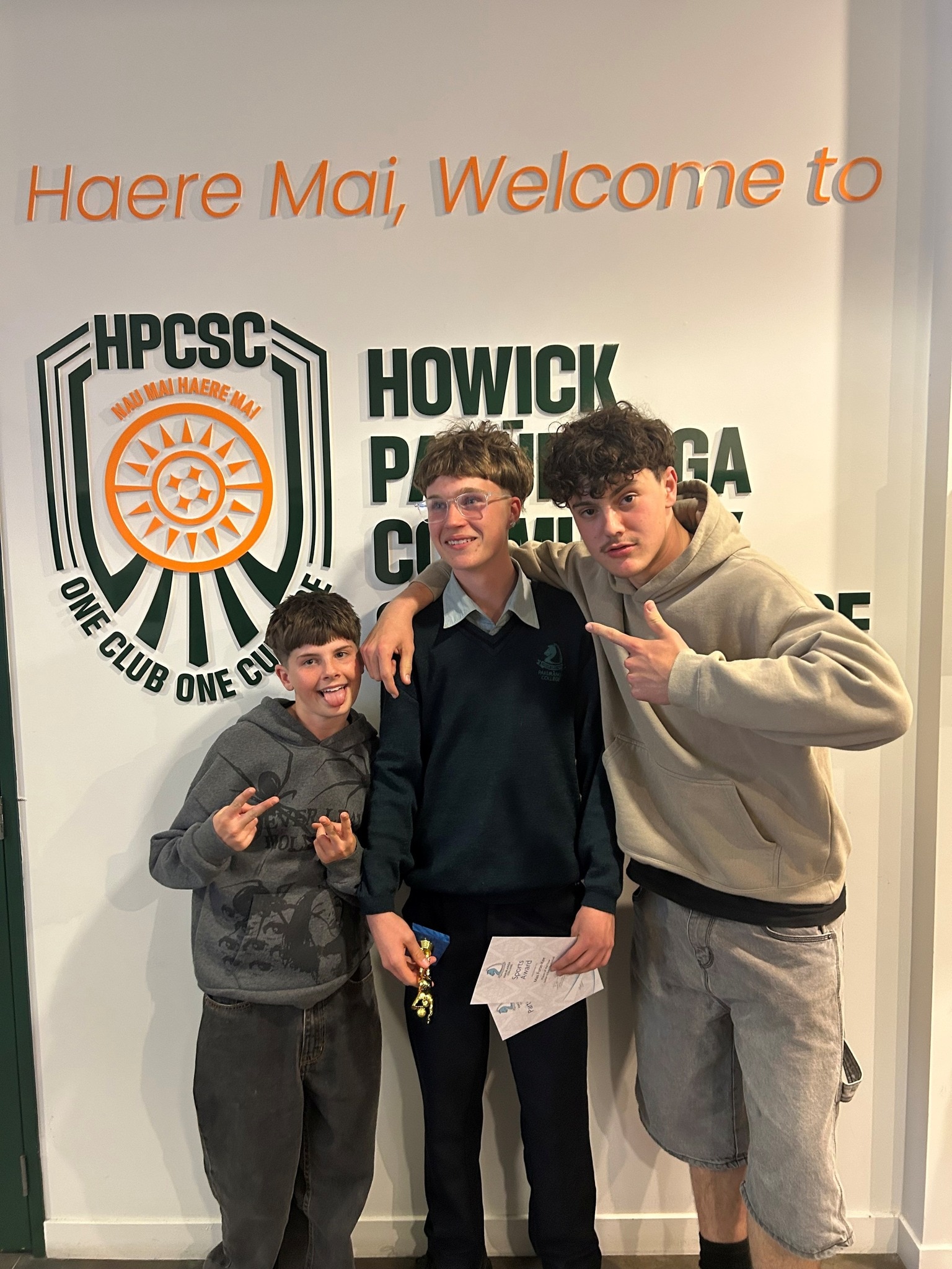 Max Furse-Kee stands between two boys. 