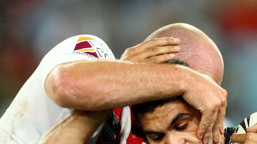 Reined in: Greg Inglis is shut down by the committed Dragons' defence.