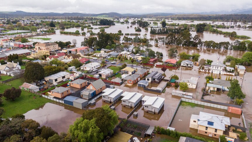 Aerial image of a rural township inundated by floodwaters.