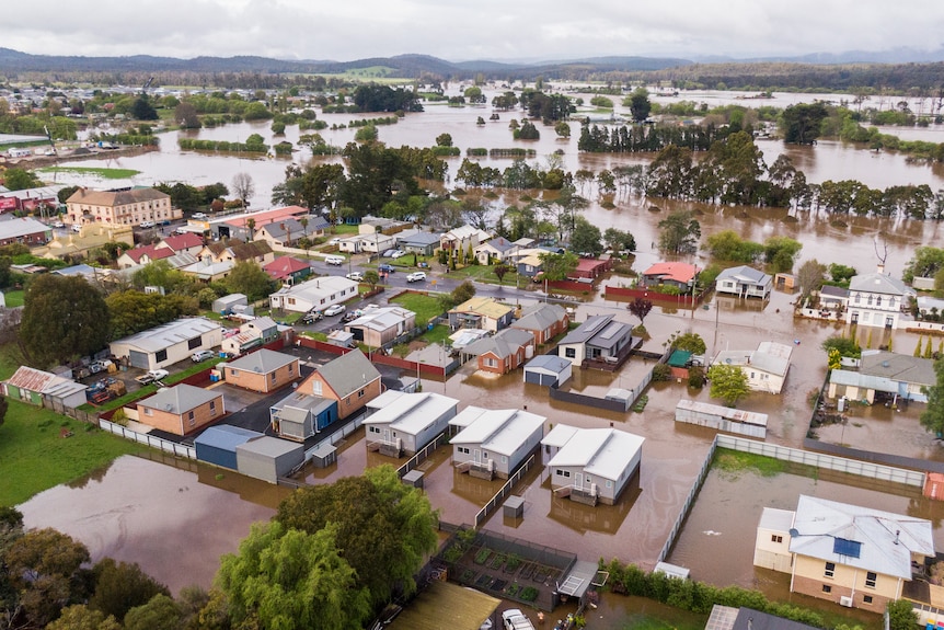 Aerial image of a rural township inundated by floodwaters.