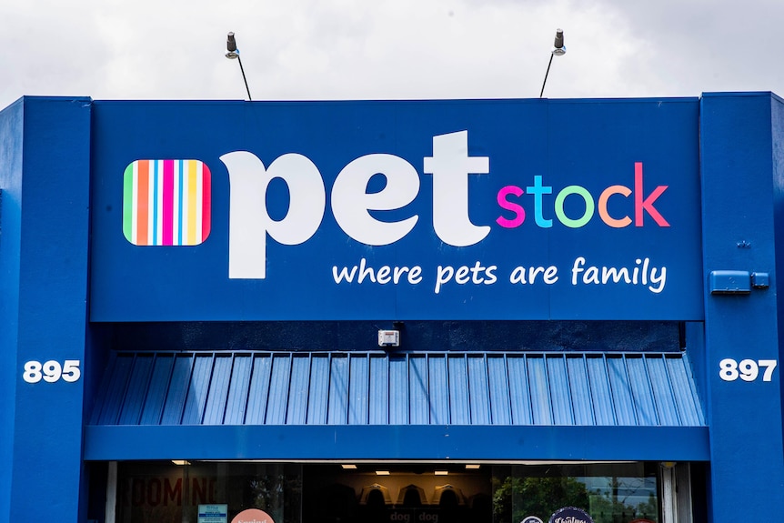 A blue building facade with a sign that reads "Pet Stock, where pets are family".