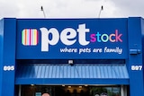 A blue building facade with a sign that reads "Pet Stock, where pets are family".