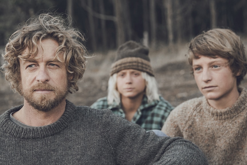 An older grizzly man with two young boys, still from the movie Breath