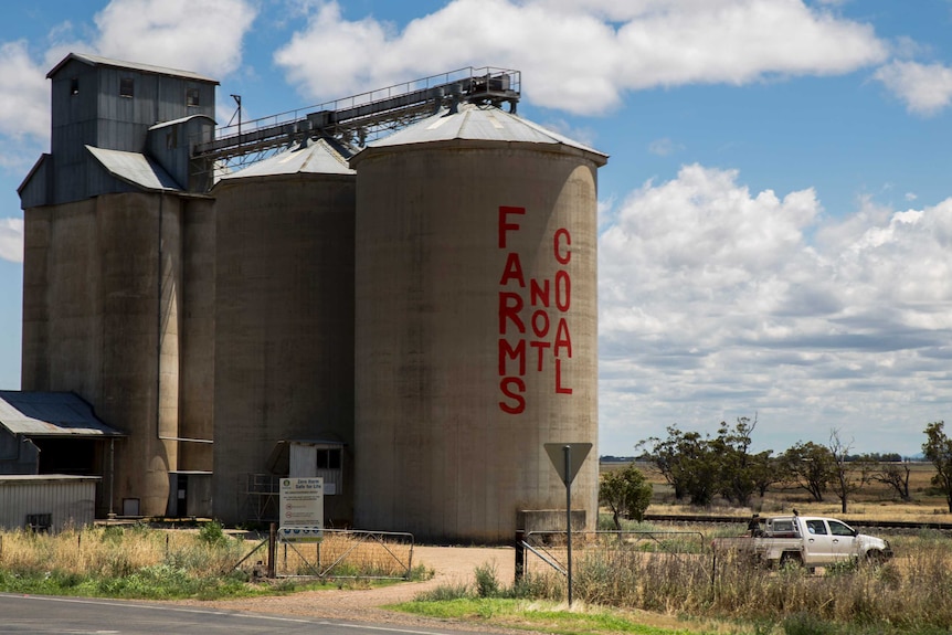 A grain silo in the Liverpool Plains painted with a sign that reads "Farms not coal".