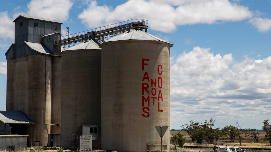 A grain silo in the Liverpool Plains painted with a sign that reads 'Farms not coal'.
